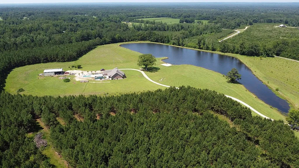 Aerial view of Magnolia Fields estate with pond and forest